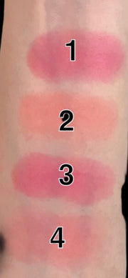 Lipstick swatches on a person's arm with numbers indicating the order of application.